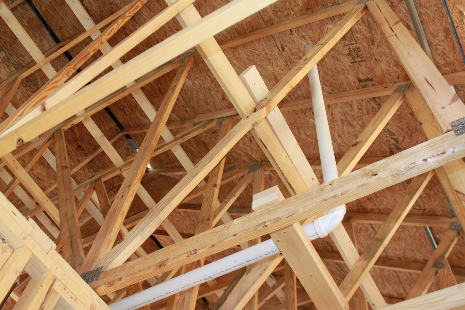 Vent piping routed through the roof framing