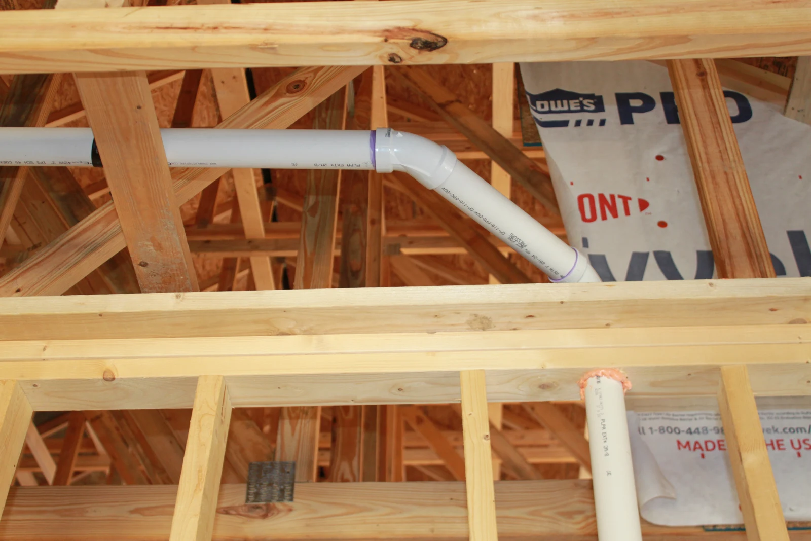 Vent piping routed above the wall framing