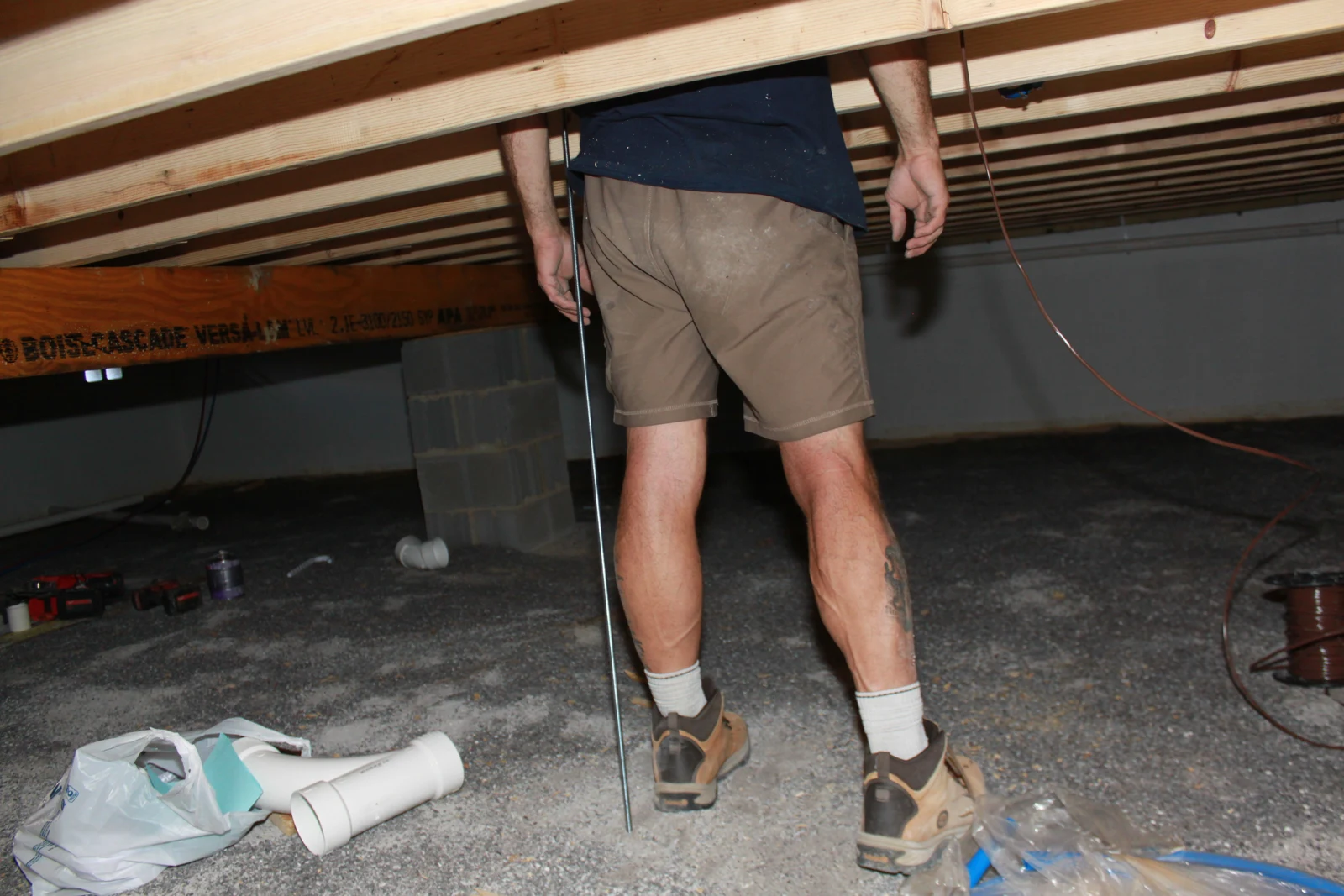 Working beneath the floor joists