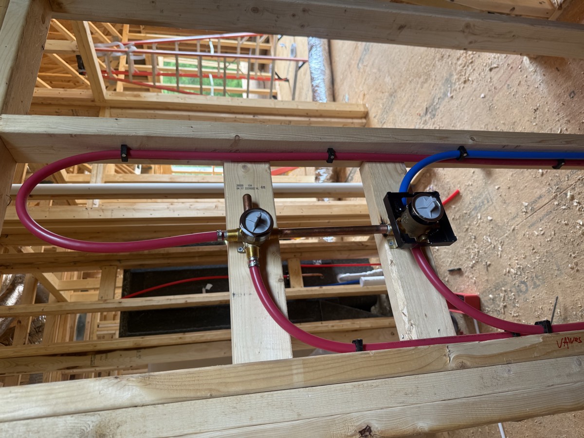PEX water lines and a shower valve roughed in on a new construction home
