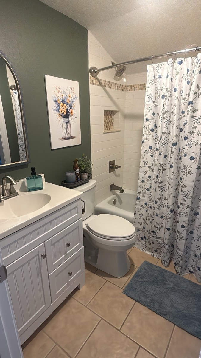 Finished bathroom remodel with a new vanity, toilet, and tub surround