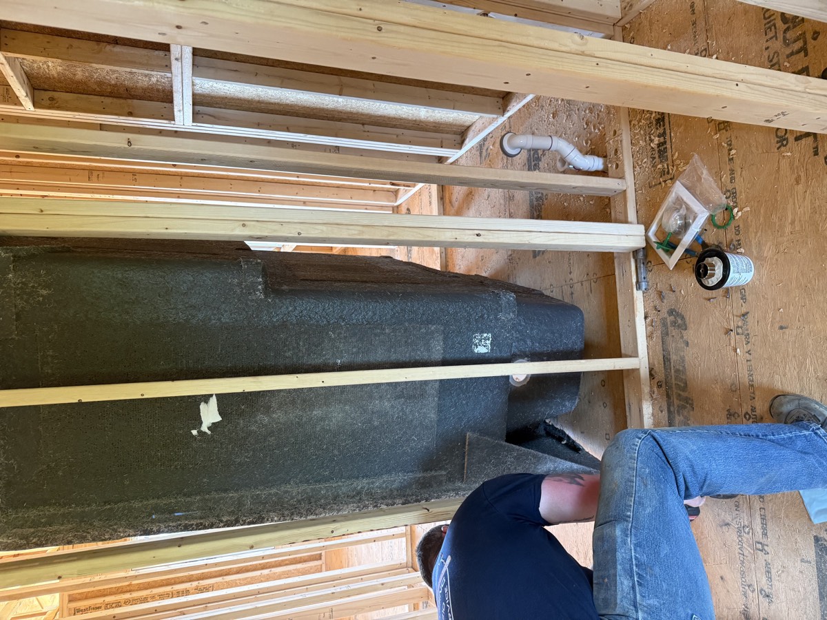 Fiberglass shower and tub surround set during a new-construction build